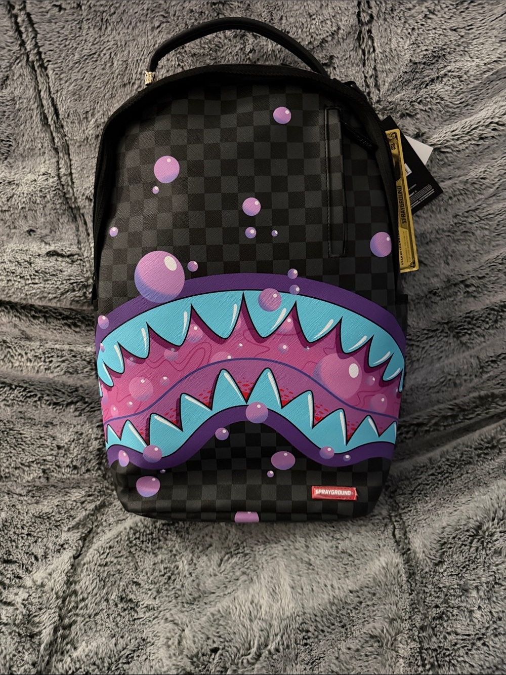 Sprayground Black Checkerboard Shark Mouth Backpack with Purple & Teal Graphics